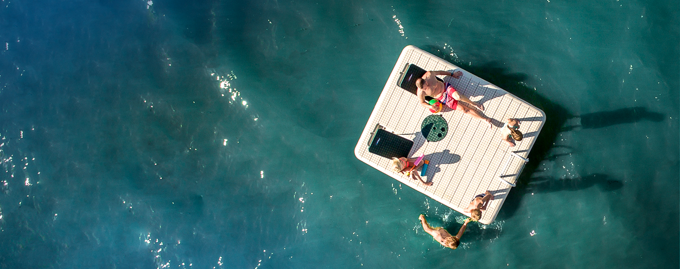 Wave Armor Otter Island Beige Swim Raft with Green Multi Angle Back Rests and Green Pop-Up Table Overhead View Lifestyle
